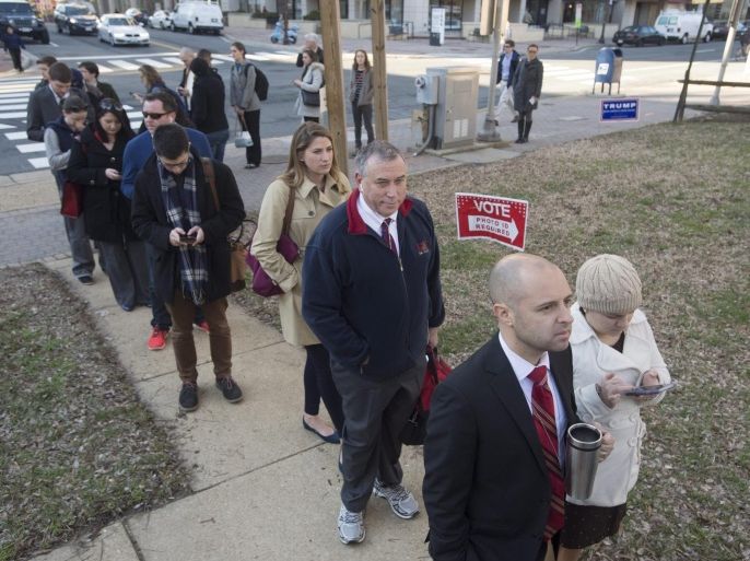 People wait in a long line to vote in the Virginia primary on Super Tuesday, at a polling station in Arlington, Virginia, USA, 01 March 2016. On 'Super Tuesday' a dozen US States (and one territory) hold their nominating contests.