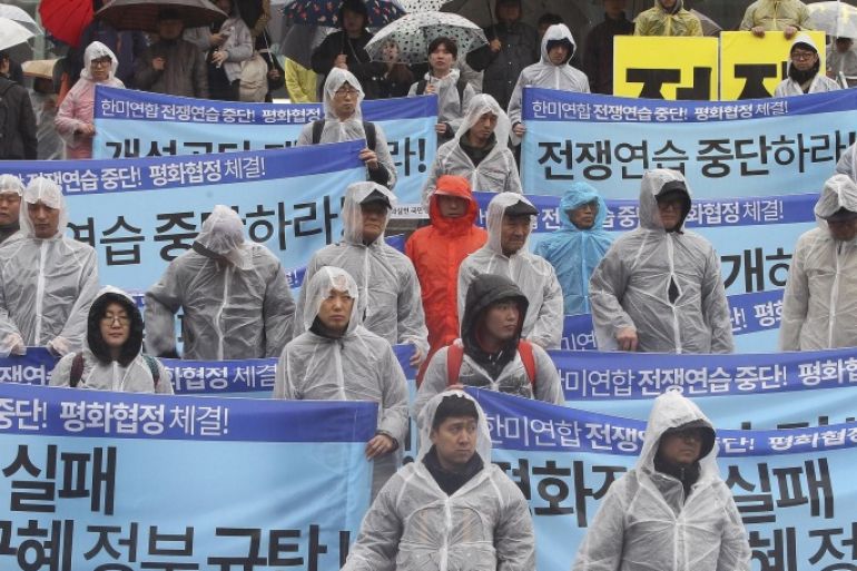 South Korean protesters stage a rally criticizing U.N. sanction on North Korea and upcoming joint military exercises between the U.S. and South Korea, in Seoul, South Korea, Saturday, March 5, 2016. North Korean leader Kim Jong Un ordered his military on standby for nuclear strikes at any time, state media reported Friday, an escalation in rhetoric targeting rivals Seoul and Washington that may not yet reflect the country's actual nuclear capacity. The banners read " Stop the joint military exercises between the U.S. and South Korea." and "Park Geun-hye, step down." (AP Photo/Ahn Young-joon)