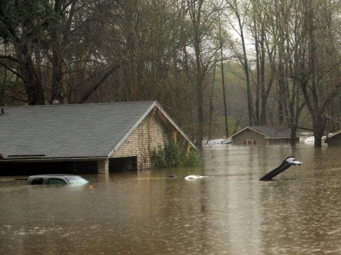 The lid of a car trunk and the top of a mailbox show how high flood waters have reached in the Tall Timbers subdivision of Haughton , La., Wednesday, March 9, 2016.Severe thunderstorms have caused major flooding and closed all schools in the area. Several parishes in northwest Louisiana have declared a state of emergency over widespread flooding, and the National Guard is being sent in to help. (AP Photo/Mike Silva)