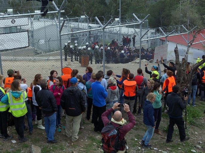 Volunteers and supporters protest outside a refugee camp in Moria, near Mytilini, Lesvos Island, Greece, 24 March 2016. The activists were protesting against newly arrived migrants being detained on Lesbos claiming violation of the Geneva convention.
