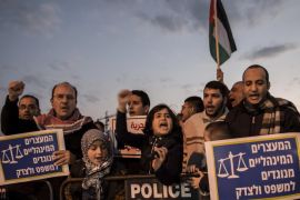 Israeli Arab demonstrators hold signs calling for the release of Palestinian journalist Mohammed al-Qeq, outside Emek hospital in the northern Israeli city of Afula, Israel, Tuesday, Feb. 9, 2016. Al-Qeq is refusing food for over 70 days to protest his six-month imprisonment without trial or charges, an Israeli practice known as administrative detention. The signs in Hebrew read: Administrative detention is against the law and justice ." (AP Photo/Tsafrir Abayov)
