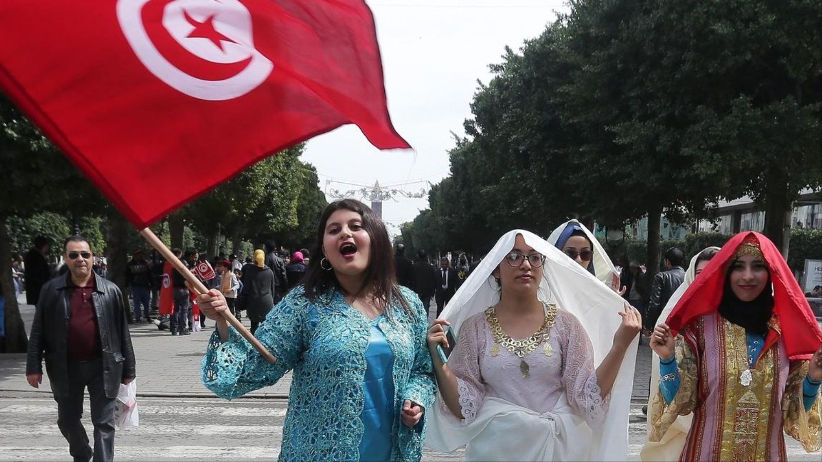 A Tunisian woman holds a national flag during a celebration to commemorate Tunisian National Day in Tunis, Tunisia, 20 March 2016. The day commemorates the country's independence from France in 1956.