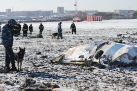 Russian investigators and policemen collect remains of bodies and inspect a site of the crash of Boeing 737-800 of FlyDubai airliner at the airport of Rostov-on-Don, Russia, 20 March 2016. Sixty two people (55 passengers and 7 crew members) died in the crash. The Boeing 737-800 crashed in the second approach of landing in very bad weather conditions.
