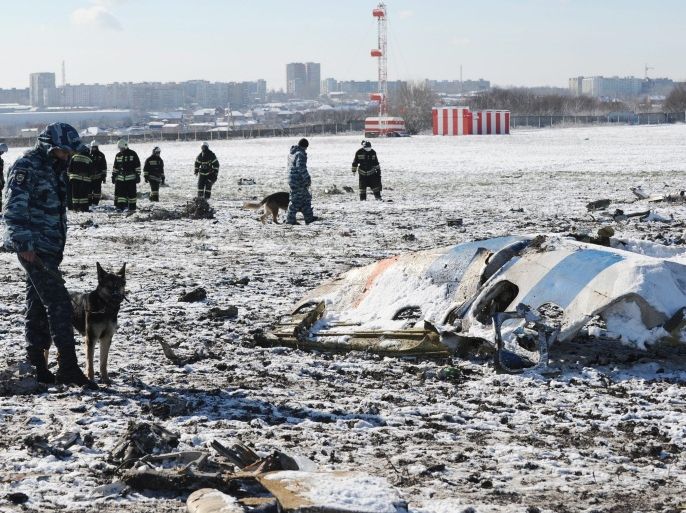 Russian investigators and policemen collect remains of bodies and inspect a site of the crash of Boeing 737-800 of FlyDubai airliner at the airport of Rostov-on-Don, Russia, 20 March 2016. Sixty two people (55 passengers and 7 crew members) died in the crash. The Boeing 737-800 crashed in the second approach of landing in very bad weather conditions.