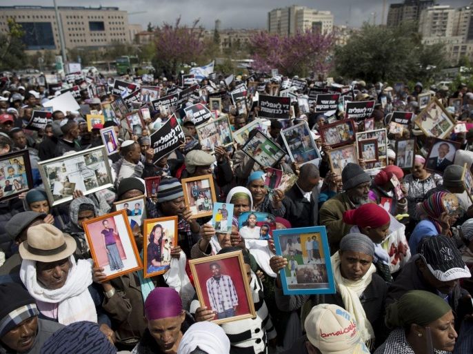 Ethiopian Jews display photographs of relatives still in Ethiopia, during a march protest held in Jerusalem toward the Israeli Prime Minister offices in Jerusalem, Israel, 20 March 2016 calling on the government to allow Ethiopian Jews still in Ethiopia, called Falash Mura, to join their relatives in Israel.
