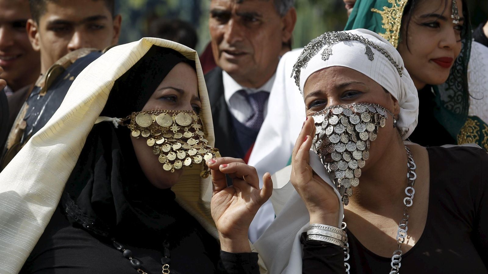 Women wear traditional veils known as "sefseri" on the National Day of Crafts and Traditional Dress in Tunis, Tunisia March 20, 2016. REUTERS/Zoubeir Souissi