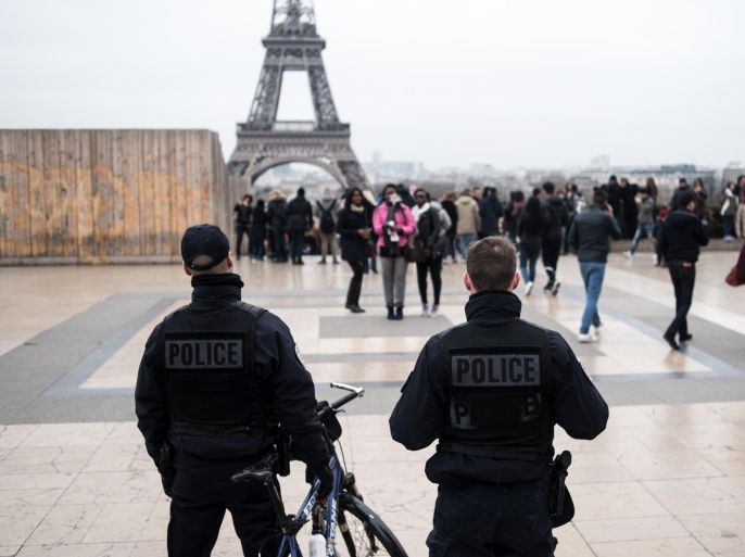 French police officers patrol at Trocadero Plaza next to the Eiffel Tower in Paris, France, Saturday, March 19, 2016. France remains under a state of emergency after the Nov. 13 attacks on a rock concert, cafes and a stadium, which claimed 130 victims. (AP Photo/Kamil Zihnioglu)