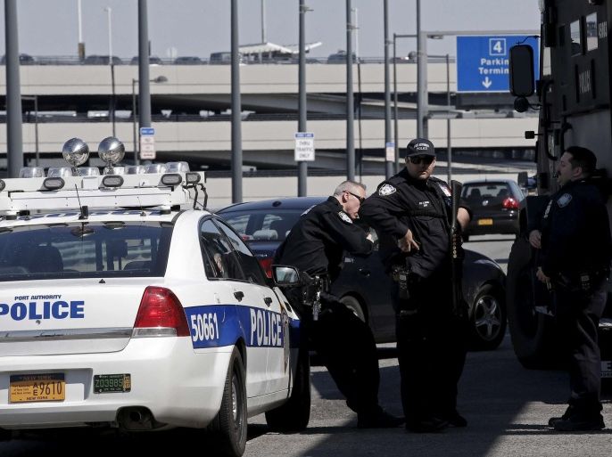 Port Authority Police officers stand guard outside a terminal at John F. Kennedy International Airport in New York on March 22, 2016. Atlanta's airport was briefly evacuated on Wednesday over a suspicious package while U.S. law enforcement agencies and travelers were on edge a day after deadly suicide bombings by Islamist militants rocked Brussels. REUTERS/Mike Segar/Files