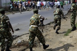 FILE - In this Monday, May 18, 2015 file photo, soldiers from a special unit disperse a group of protesters by firing in the air in the Musage neighborhood of Bujumbura, Burundi. The U.N. human rights chief Zeid Raad al-Hussein warned Friday, Jan. 15, 2016 of worrying trends in Burundi such as gang-rapes of women by security forces, torture and signs of ethnic repression in nine months of simmering violence and repression. (AP Photo/Jerome Delay, File)