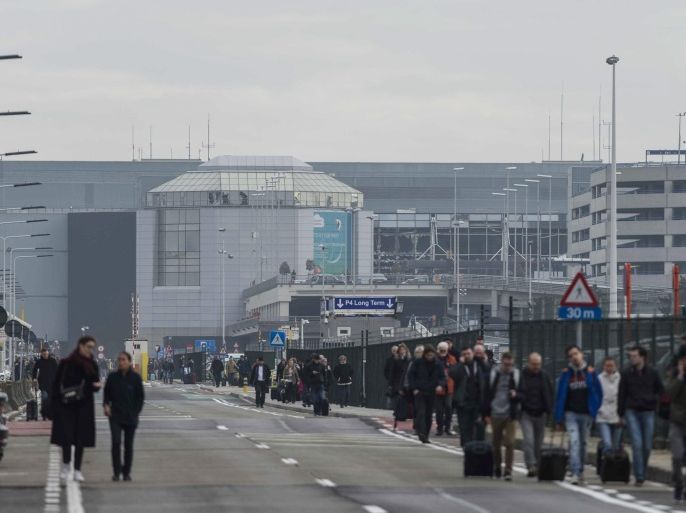 Passengers are evacuated from the terminal building after explosions at Brussels Airport in Zaventem near Brussels, Belgium, 22 March 2016. Dozens of people have died or been injured in a double blast in the departure hall of Zaventem Airport in Brussels, Belgian media reported.