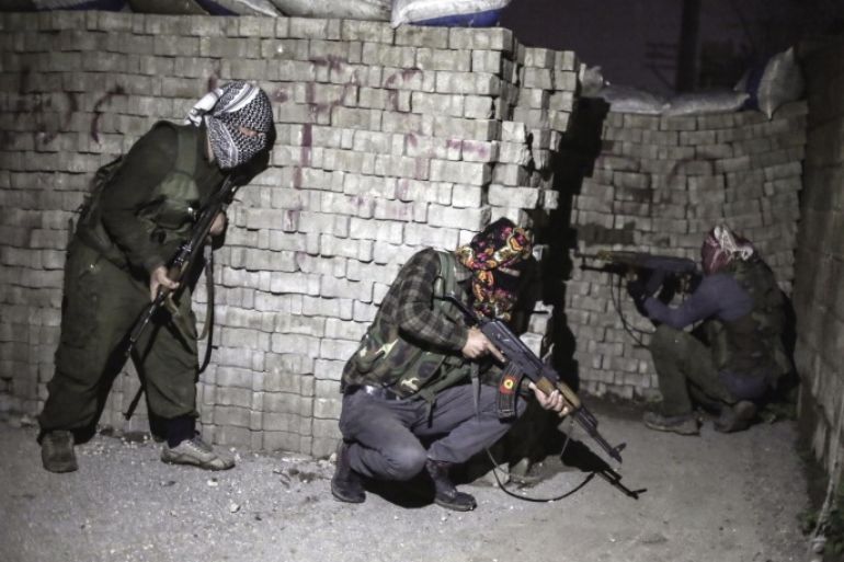 In this photo dated Thursday Feb. 25, 2016, militants of Kurdistan Workers' Party, PKK, move to attack Turkish security forces in Nusaybin, south Turkey, Thursday, Feb. 25, 2016. Turkish authorities say a curfew in southeastern Turkey will be lifted at 5 a.m. on Wednesday March 2, 2016. (AP Photo/Cagdas Erdogan)