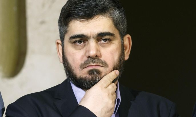 Mohammed Alloush, chief negotiator for the main Syrian opposition body and rebel group Army of Islam, listens during a briefing after a round of negotiation between the Syrian opposition and the UN Special Envoy of the Secretary-General for Syria Staffan de Mistura at the European headquarters of the United Nations in Geneva, Switzerland, Friday, April 15, 2016. (Salvatore Di Nolfi/Keystone via AP)
