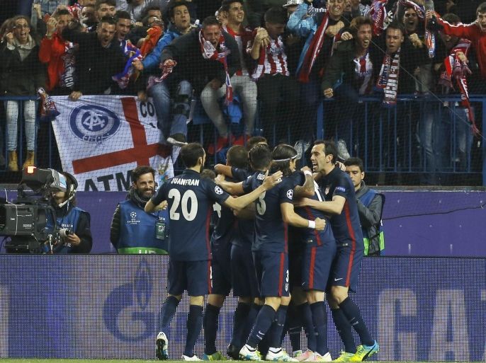 Atletico players celebrate scoring their side's first goal during the Champions League 2nd leg quarterfinal soccer match between Atletico Madrid and Barcelona at the Vicente Calderon stadium in Madrid, Spain, Wednesday April 13, 2016. (AP Photo/Francisco Seco)