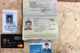 FILE -- In this file photo released by the Egyptian Ministry of Interior on Thursday, Mar. 24, 2016, personal belongings of slain Italian graduate student Giulio Regeni, including his passport, are displayed. On Sunday, April 3, 2016 the editor of Egypt's top state newspaper called on Egyptian authorities to seriously deal with the case of an Italian student tortured and killed in Cairo, saying officials who didn't realize the gravity of the case are risking Egyptian-Italian relations. Italian Premier Matteo Renzi has insisted Italy will settle for nothing less than the truth. (Egyptian Interior Ministry via AP, File)