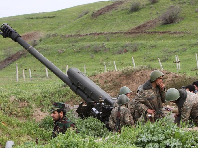 Karabakh Armenian soldiers stand near a howitzer in Hadrut province in Nagorno-Karabakh, Azerbaijan, Tuesday, April 5, 2016. Azerbaijan forces and separatist forces in Nagorno-Karabakh agreed on a cease-fire Tuesday following three days of the heaviest fighting in the region since 1994, the Azeri defense ministry announced. (Albert Khachatryan/Photolure via AP)