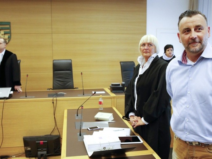 Lutz Bachmann (R), co-founder of Patriotic Europeans Against the Islamisation of the West (PEGIDA), stands in a courtroom next to judge Hans Hlavka (L) and lawyer Katja Reichel before his trial to be charged with incitement over Facebook posts in a court in Dresden, Germany, 19 April 2016.