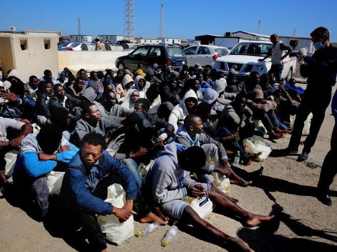 African illegal migrants wait to receive medial assistance after being rescued by coastal guards on a port in Tripoli, Libya, Monday, April 11, 2016. More than 100 migrants were rescued by two coastal guards on Monday after their boat started sinking in the sea. (AP Photo/Mohamed Ben Khalifa)