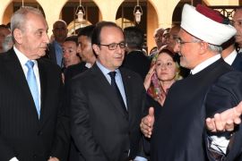In this photo released by the Lebanese Parliament media office, French President Francois Hollande, center, stands next of Lebanese Parliament Speaker Nabi Berri, left, welcome by a Sunni sheikh during their visit to Al-Omari mosque, in downtown Beirut, Lebanon, Saturday, April 16, 2016. Hollande has arrived in Beirut at the start of a regional tour that will take him to Egypt and Jordan. During his two-day visit to Lebanon, the French president is scheduled to meet senior officials and visit a group of Syrian refugees in the country's eastern Bekaa Valley. (Ali Fawaz, Lebanese Parliament Media Office via AP)