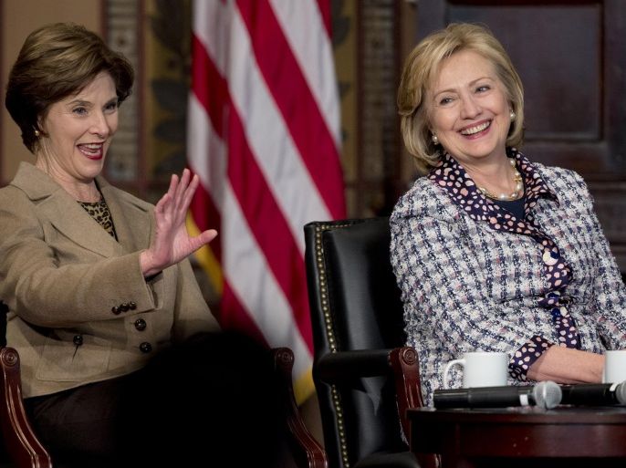 Former first lady Laura Bush, left, and former Secretary of State Hillary Rodham Clinton, sit together on stage in Gaston Hall at Georgetown University in Washington, Friday, Nov. 15, 2013, during the "Advance Afghan Women" symposium. Secretary of State John Kerry and his predecessor, Clinton, say Afghanistan is reaching a turning point that will be critical to maintaining advances made by women since the end of Taliban rule. (AP Photo/Carolyn Kaster)