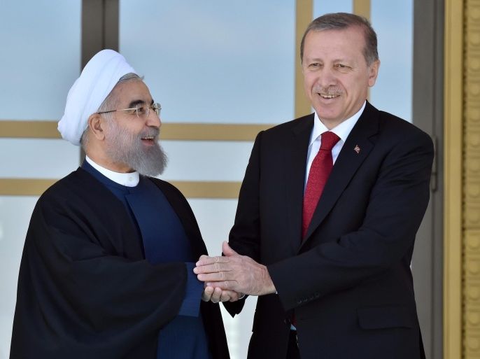 A handout picture provided by the Turkish President Press Office shows the Turkish President Recep Tayyip Erdogan (R) welcoming the Iranian President Hassan Rouhani (L) at the Presidential Palace in Ankara, Turkey, 16 April 2016. The meeting comes one day after the 13th Organization of Islamic Cooperation summit has ended in Istanbul. EPA/TURKISH PRESIDENT PRESS OFFICE / HANDOUT