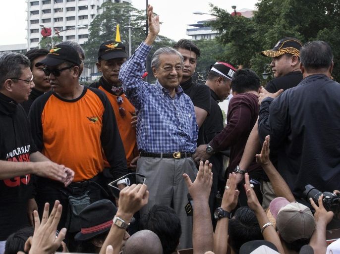 Former Malaysian Prime Minister, Mahathir Mohamad (C) waves towards supporters at an anti-GST (Goods and Services Tax) rally to commemorate one-year anniversary of its implementation in Kuala Lumpur, Malaysia, 02 April 2016. Protesters were calling for an end to the GST, release of jailed opposition leader, Anwar Ibrahim and the resignation of the Prime Minister, Najib Razak.