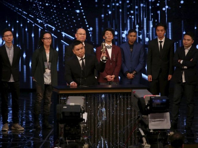 Executive producer Andrew Choi lifts a trophy in front of directors and cast members of movie "Ten Years” after winning the Best Film award at the Hong Kong Film Awards in Hong Kong, China April 3, 2016. REUTERS/Stringer EDITORIAL USE ONLY. NO RESALES. NO ARCHIVE
