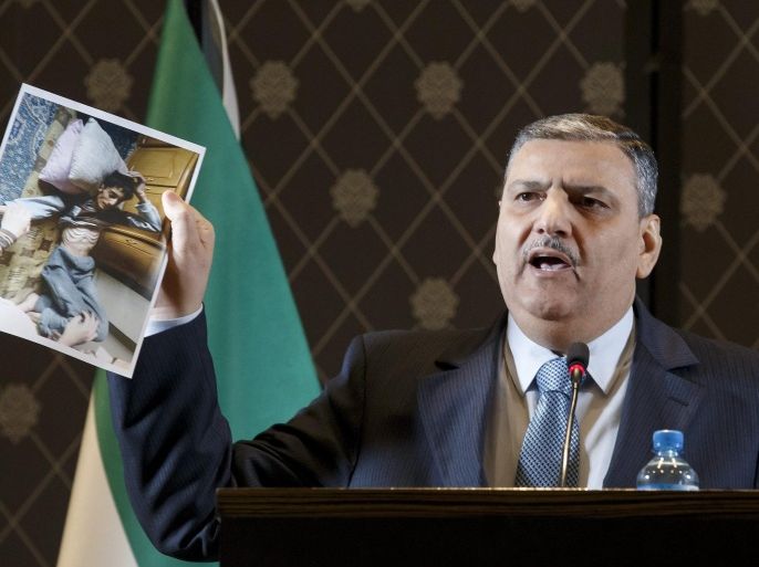 Riad Hijab, Coordinator of the High Negotiation Committee (HNC), shows a picture to the media during a press conference, in Geneva, Switzerland, 19 April 2016. Reports on 18 April state Syrian opposition called for suspending the peace talks currently ongoing in Geneva saying the Syrian regime was violating the ceasefire. A total of 10 Syrian armed rebel groups declared that they will jointly respond in a coordinated manner to violations committed by the government forces to the cease-fire, in force since 27 February.