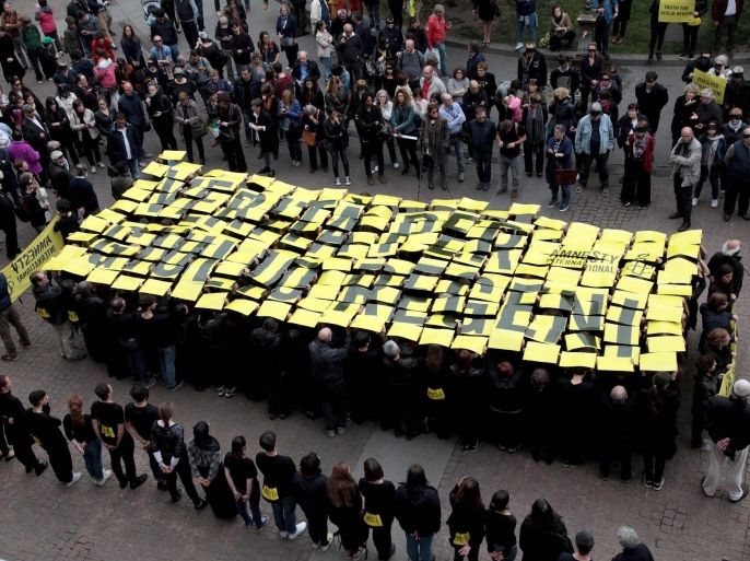 People show the slogan 'Truth for Giulio Regeni' as they take part in a protest action in, Milan, Italy, 24 April 2016. Giulio Regeni, an Italian doctoral student, disappeared in Cairo on 25 January. His body, stabbed repeatedly and exhibiting cigarette burns and other signs of torture, was reportedly found on 03 February. The slogan reads
