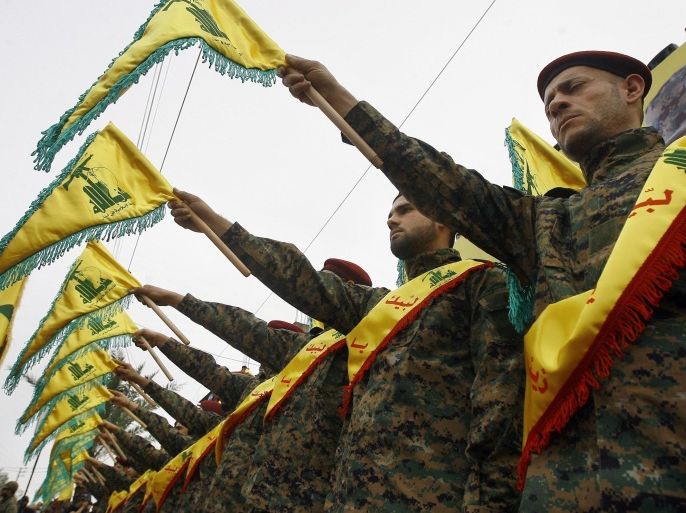 FILE - In this Wednesday, March 2, 2016 photo, Hezbollah fighters hold flags as they attend the funeral procession of Hezbollah senior commander, Ali Fayyad, who was killed last week during an offensive by Syrian troops and Hezbollah fighters in Syria, in the southern Lebanese village of Ansar, Lebanon. Fayyad was a Hezbollah veteran who had led major battles against the Israeli army in south Lebanon. A Saudi-led bloc of six Gulf Arab nations formally branded Hezbollah a terrorist organization on Wednesday, ramping up the pressure on the Lebanese militant group fighting on the side of President Bashar Assad in Syria. (AP Photo/Mohammed Zaatari, File)