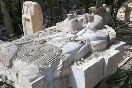 FILE - This photo released on Sunday March 27, 2016, by the Syrian official news agency SANA, shows a destroyed statue outside the damaged Palmyra Museum, in Palmyra city, central Syria. Polish experts back from assessing damage at the museum in the Syrian city of Palmyra offer grim new details about the extent of the destruction caused by the Islamic State group. The museum was trashed and some of its best-known artifacts and statues were smashed by the extremists during the 10 months they controlled the town, before being driven out last month. (SANA via AP, File)