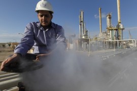 FILE - In this Feb. 26, 2011, file photo, an employee works at a refinery inside the Brega oil complex, in Brega, eastern Libya. OPEC produces one-third of the world’s oil and, in theory, at least, can affect global oil prices depending on how much oil it decides to sell. In reality, OPEC member countries have different, often conflicting priorities and don’t adhere to the cartel’s official targets for production. (AP Photo/Hussein Malla, File)