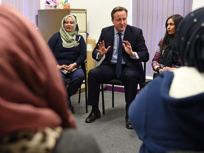 Britain's Prime Minister David Cameron, center, meets women attending an English language class during a visit to the Shantona Women's Centre in Leeds, Monday, Jan. 18, 2016. Cameron told the BBC on Monday that Muslim women must improve their English skills to better integrate into British society, and suggested some migrants could be deported if they fail to better speak the language. (Oli Scarff/PA via AP) UNITED KINGDOM OUT