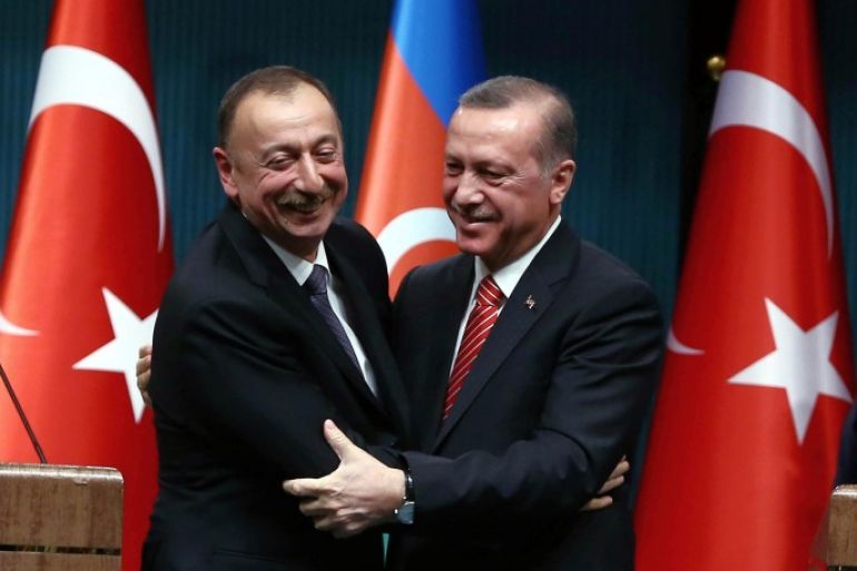 Turkey's President Recep Tayyip Erdogan, right, and Azerbaijan's President Ilham Aliyev hug each other after a joint news conference in Ankara, Turkey, Tuesday, March 15, 2016. Aliyev is in Ankara in solidarity with Turkey after Sunday's deadly explosion. (AP Photo)
