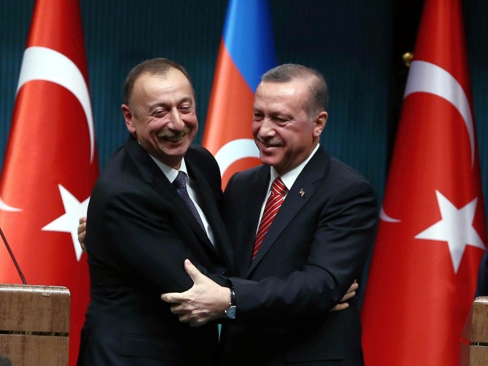Turkey's President Recep Tayyip Erdogan, right, and Azerbaijan's President Ilham Aliyev hug each other after a joint news conference in Ankara, Turkey, Tuesday, March 15, 2016. Aliyev is in Ankara in solidarity with Turkey after Sunday's deadly explosion. (AP Photo)