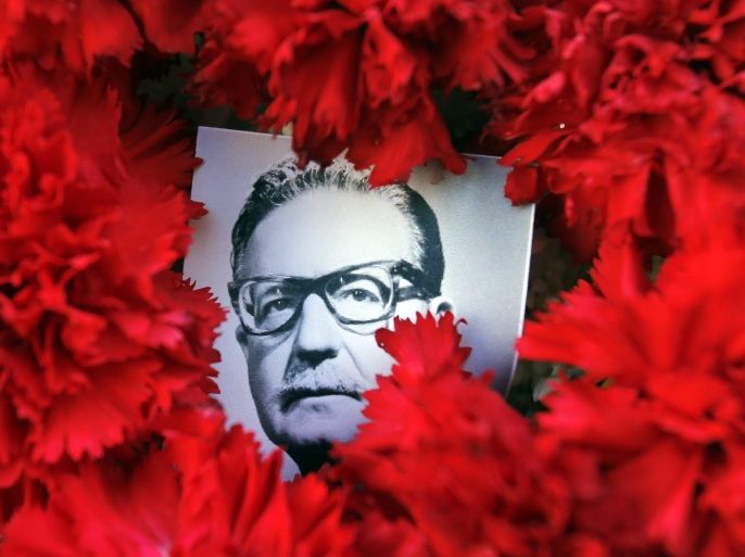 Flowers frame a picture of late Chilean president Salvador Allende at the door of Chile's Presidential Palace, La Moneda in commemoration of the 41st anniversary of the coup against by Augusto Pinichet, in Santiago de Chile, Chile, 11 September 2014.