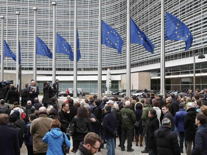 People observe a minute of silence outside the EU Commission Headquarters in Brussels following Tuesday's bomb attacks in Brussels, Belgium, March 23, 2016. REUTERS/Francois Lenoir