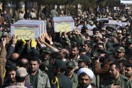 Civilians and armed forces members carry the flag draped coffins of Iranian Revolutionary Guard's Gen. Mohsen Ghajarian, left, and some of his comrades who were killed in fighting in Syria, during their funeral ceremony outside the headquarters of the guard's ground forces in Tehran, Iran, Saturday, Feb. 6, 2016. (AP Photo/Vahid Salemi)
