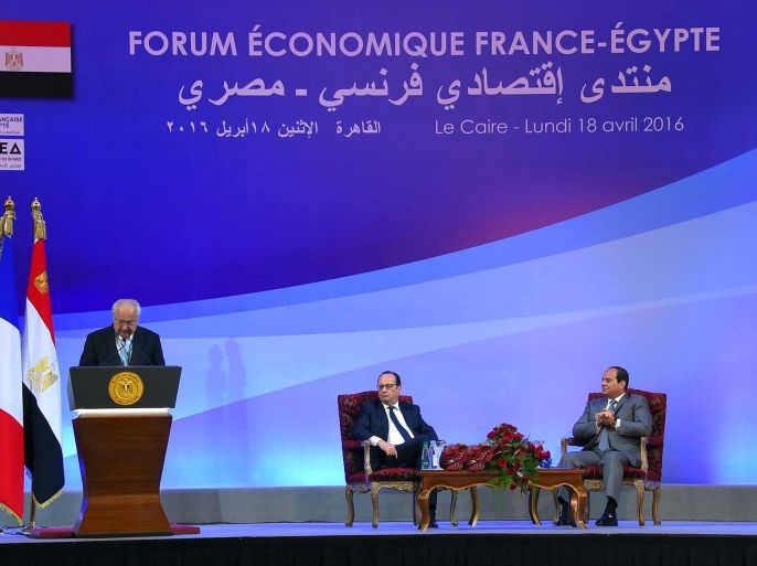 In this photo provided by Egypt's state news agency MENA, Egyptian President Abdel-Fattah el-Sissi, right, and French President Francois Hollande, center, attend an economic conference in Cairo, Egypt, Monday, April 18, 2016. In Egypt as part of a three-nation Middle East tour, the French leader was accompanied by a large business delegation. Hollande and el-Sissi are expected to sign accords in the fields of energy, infrastructure and culture, according to an Egyptian presidential statement. (Mohammed Abdul Moaty/MENA via AP)