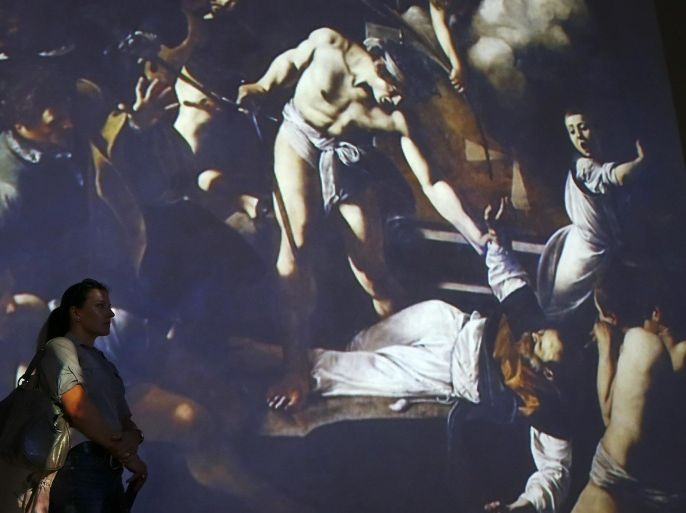 A visitor watches a video installation entitled "Caravaggio Experience" realized by video designer Stefano Fake and exhibited at the Palazzo delle Esposizioni in Rome, Italy March 31, 2016. REUTERS/Tony Gentile EDITORIAL USE ONLY. NO RESALES. NO ARCHIVE