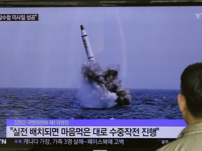 FILE - In this Saturday, May 9, 2015, file photo, a South Korean man watches a TV news program showing an image published in North Korea's Rodong Sinmun newspaper of North Korea's ballistic missile believed to have been launched from underwater, at Seoul Railway station in Seoul, South Korea. When North Korea announced it had successfully launched a missile from a submarine, experts said it may have actually been fired from an underwater testing barge. (AP Photo/Ahn Young-oon, File)