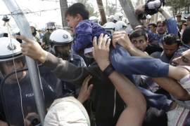 Migrants clash with Greek police during a protest against the closed border with Macedonia, at the northern Greek border point of Idomeni, Greece, Thursday, April 7, 2016. When the migrants tried to tear down part of the fence, Macedonian police stepped in and stopped them. (AP Photo/Amel Emric)