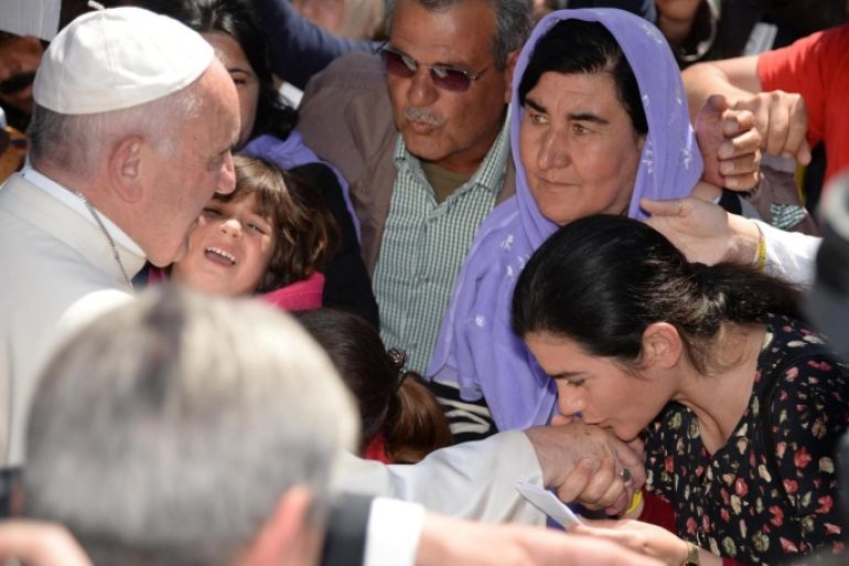 Pope Francis greets migrants and refugees at the Moria refugee camp near the port of Mytilene on the island of Lesbos, Greece, 16 April 2016. Pope Francis visits the Greek island of Lesbos on 16 April, in a trip aimed at supporting refugees and drawing attention to the frontline of Europe's migration crisis.