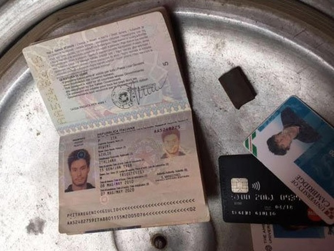In this photo released by the Egyptian Ministry of Interior on Thursday, Mar. 24, 2016, personal belongings of slain Italian graduate student Giulio Regeni, including his passport, are displayed. Egypt's Interior Ministry said Thursday it has killed members of a gang suspected of being linked to the killing Regini student whose torture and death sparked an international outcry over possible involvement of Egyptian police in his brutal killing. The ministry said that police raided one of the men's houses and found the personal belongings of Regeni, including his red handbag bearing the picture of the Italian flag, his passport and other identification cards, including one belonging to Cambridge University, in addition to his cellphones. (Egyptian Interior Ministry via AP)