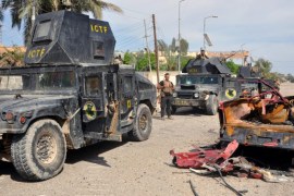 A photograph made available on 15 April 2016 shows Iraqi military convoy stand next to a truck destroyed during the clashes with Islamic state group in the recently recaptured city of Heet, western Iraq, 14 April 2016. Iraqi security forces gained full control over the key city of Heet, western capital province of Anbar after days of fierce clashes with Islamic state group, a military source said. EPA/NAWRAS AAMER ATTENTION EDITORS: GRAPHIC CONTENT