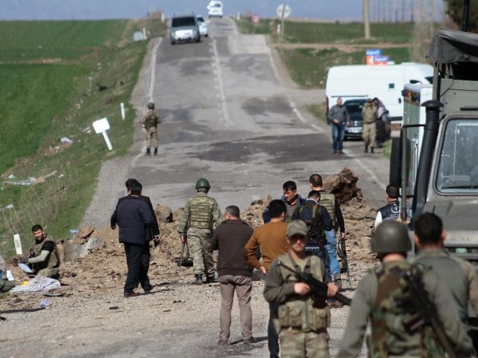 Turkish soldiers stand near a damaged road after a bomb attack on the main road to Diyarbakir, Turkey, 18 February 2016. At least six Turkish soldiers are dead after a bomb attack in the south-eastern province of Diyarbakir, the military says. One soldier was wounded in the attack. The army has blamed the banned Kurdistan Workers' Party (PKK) for the bombing and claims the attack was targeting a military convoy.