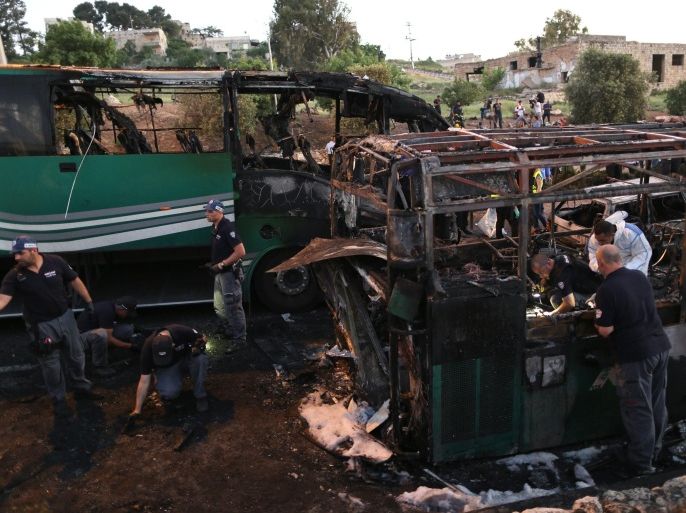 Israeli police officers work at the scene of a bus explosion in Jerusalem, Monday, April 18, 2016. A bus exploded in the heart of Jerusalem Monday, wounding at least 15 people who appeared to have been in an adjacent bus that was also damaged. The explosion raised fears of a return to the Palestinian suicide attacks that ravaged Israeli cities a decade ago. (AP Photo/Oded Balilty)