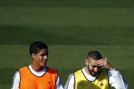 Real Madrid's Karim Benzema (R) gestures next to teammate Raphael Varane during a training session at the team's training grounds outside Madrid, Spain, November 7, 2015. French Real Madrid striker Karim Benzema was placed under formal judicial investigation on Thursday in connection with an alleged attempt to blackmail fellow-France soccer international Mathieu Valbuena with the use of a sex video. REUTERS/Susana Vera