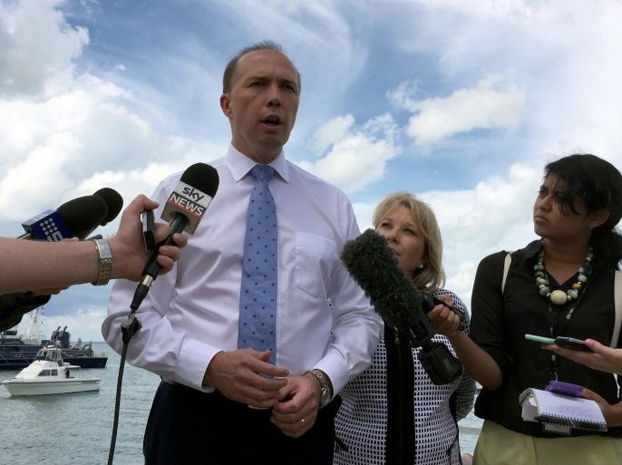 Australia's Immigration Minister Peter Dutton (C) speaks to members of the media at East Arm Wharf in Darwin, Australia, 17 December 2015. Dutton was in the Northern Territory to announce that Australian Border Force will be permanently berthed at the Darwin Port in order to continue anti-people smuggler and narcotics trafficking operations. EPA/NEDA VANOVAC AUSTRALIA AND NEW ZEALAND OUT