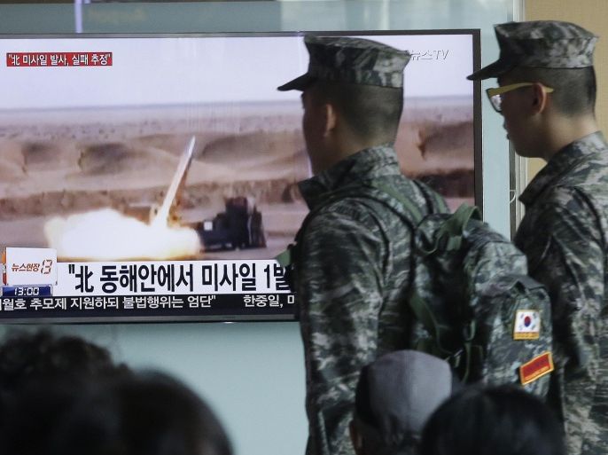 South Korean army soldiers pass by a TV news program showing a file footage of a missile launch conducted by North Korea at Seoul Railway Station in Seoul, South Korea, Friday, April 15, 2016. A North Korean launch of a missile on the birthday of its revered founder appears to have failed, South Korean and U.S. defense officials said Friday. The letters at a screen read: "North Korea launched a missile from its east coast." (AP Photo/Ahnn Young-joon)