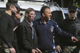 Cyprus police officers escort EgyptAir plane hijacking suspect Seif Eddin Mustafa, third right, to a court for a remand hearing as authorities investigate him on charges including hijacking, illegal possession of explosives and abduction in the Cypriot coastal town of Larnaca Wednesday, March 30, 2016. The Egyptian man described as "psychologically unstable" hijacked a flight Tuesday from Egypt to Cyprus and threatened to blow it up. His explosives turned out to be fake, and he surrendered with all passengers released unharmed after a bizarre six-hour standoff. (AP Photo/Petros Karadjias)